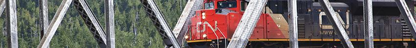 CN freight train going through steel bridge.